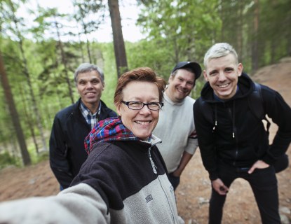 Eri-ikäisiä henkilöitä luontopolulla
